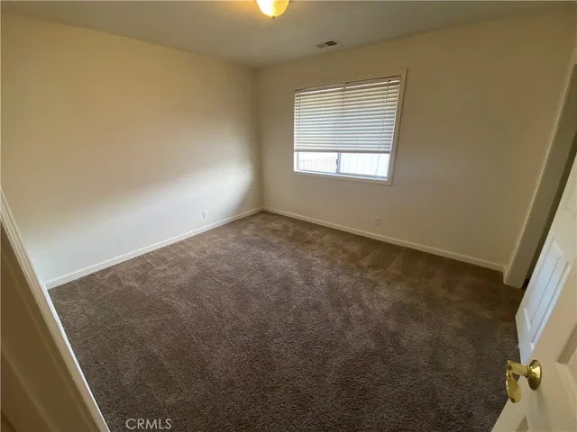 an empty room with a empty space and windows