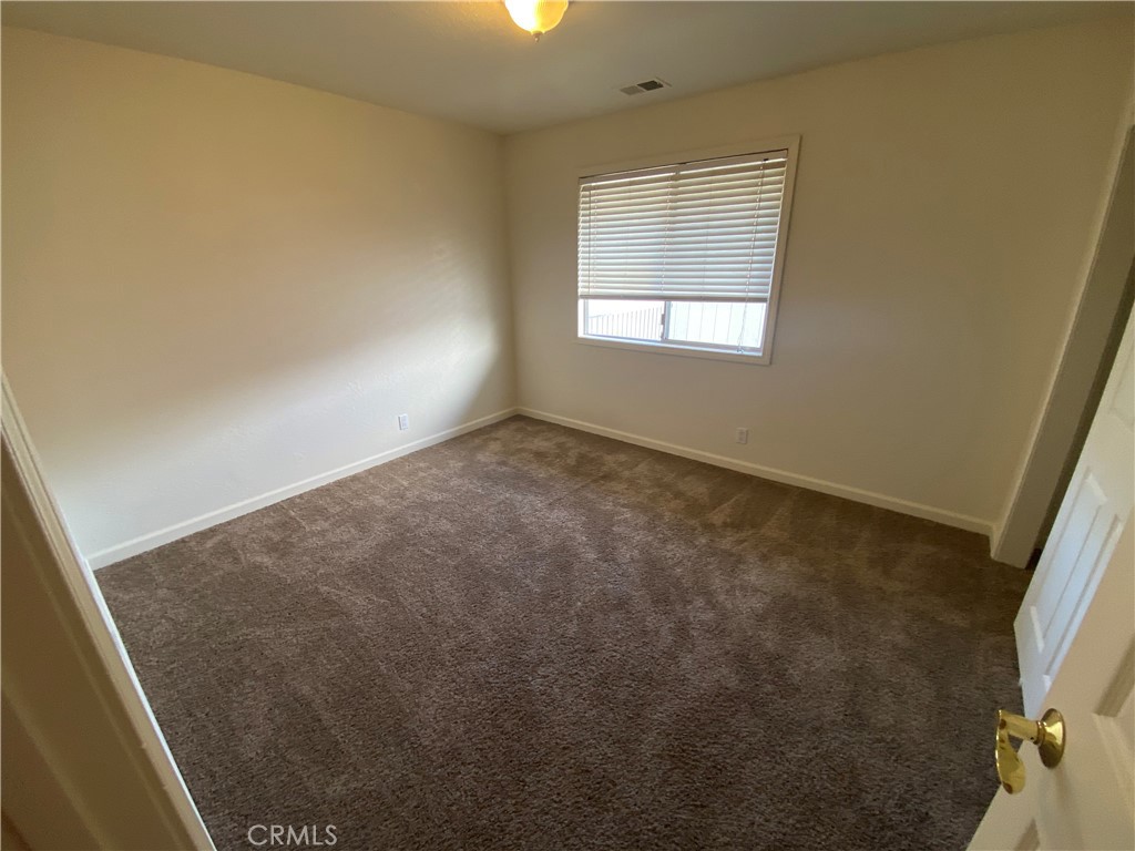 19790 Oak Flat Road Hidden Valley Lake, CA 95467 - Photo 19 of 23 an empty room with a empty space and windows