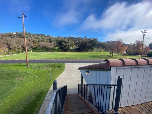 a view of a deck with a big yard
