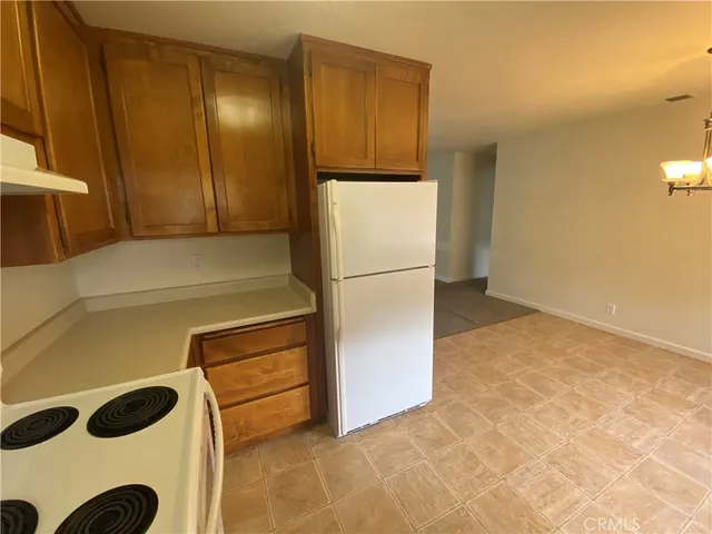 a kitchen with a refrigerator and a stove