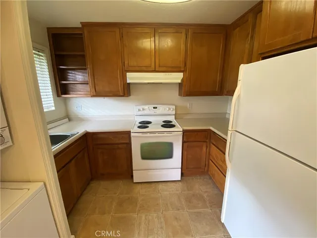 a kitchen with a stove a sink and a refrigerator