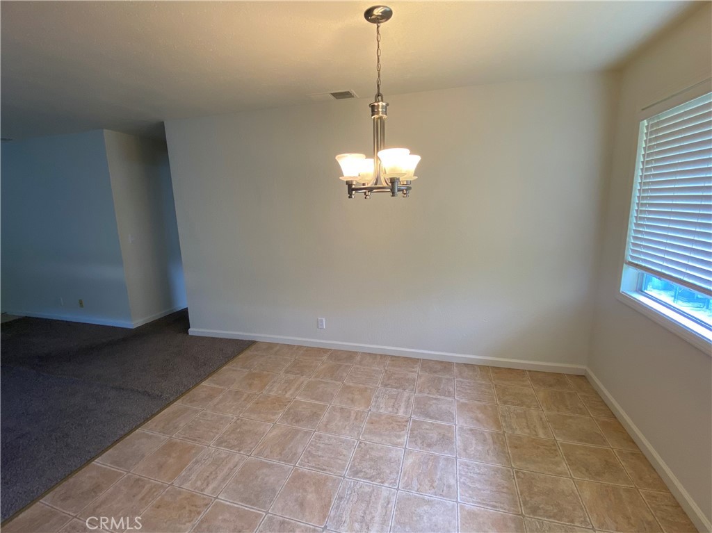 19790 Oak Flat Road Hidden Valley Lake, CA 95467 - Photo 8 of 23 a view of an empty room with a chandelier fan