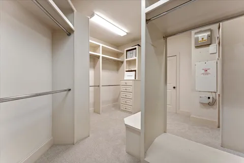 an empty room with a fan and a fan