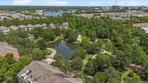 an aerial view of a house with swimming pool and garden