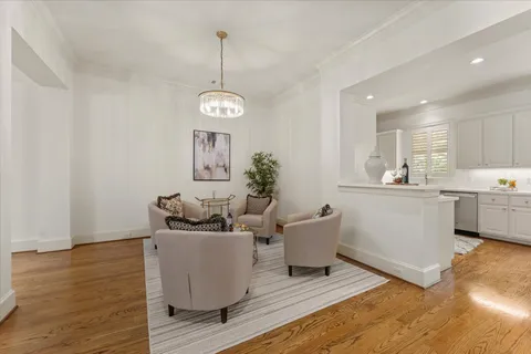 a kitchen with stainless steel appliances kitchen island granite countertop a sink stove refrigerator and cabinets