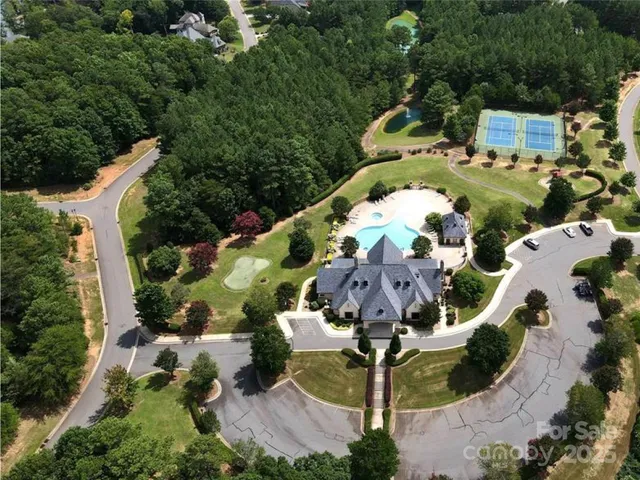 an aerial view of house with yard swimming pool and outdoor seating
