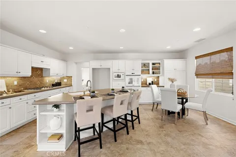 a view of kitchen with cabinets table and chairs