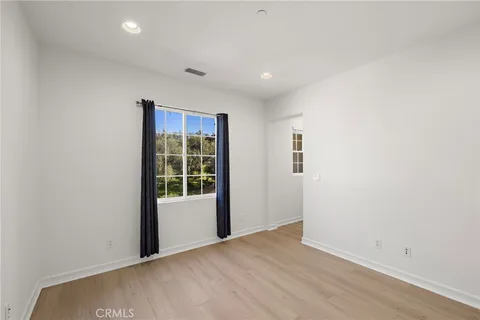 a bathroom with a toilet sink double vanity and mirror