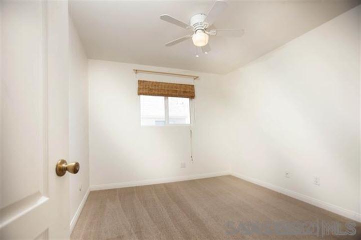 815 Del Mar Downs Road, Unit C Solana Beach, CA 92075 - Photo 13 of 19 an empty room with a ceiling fan and a window