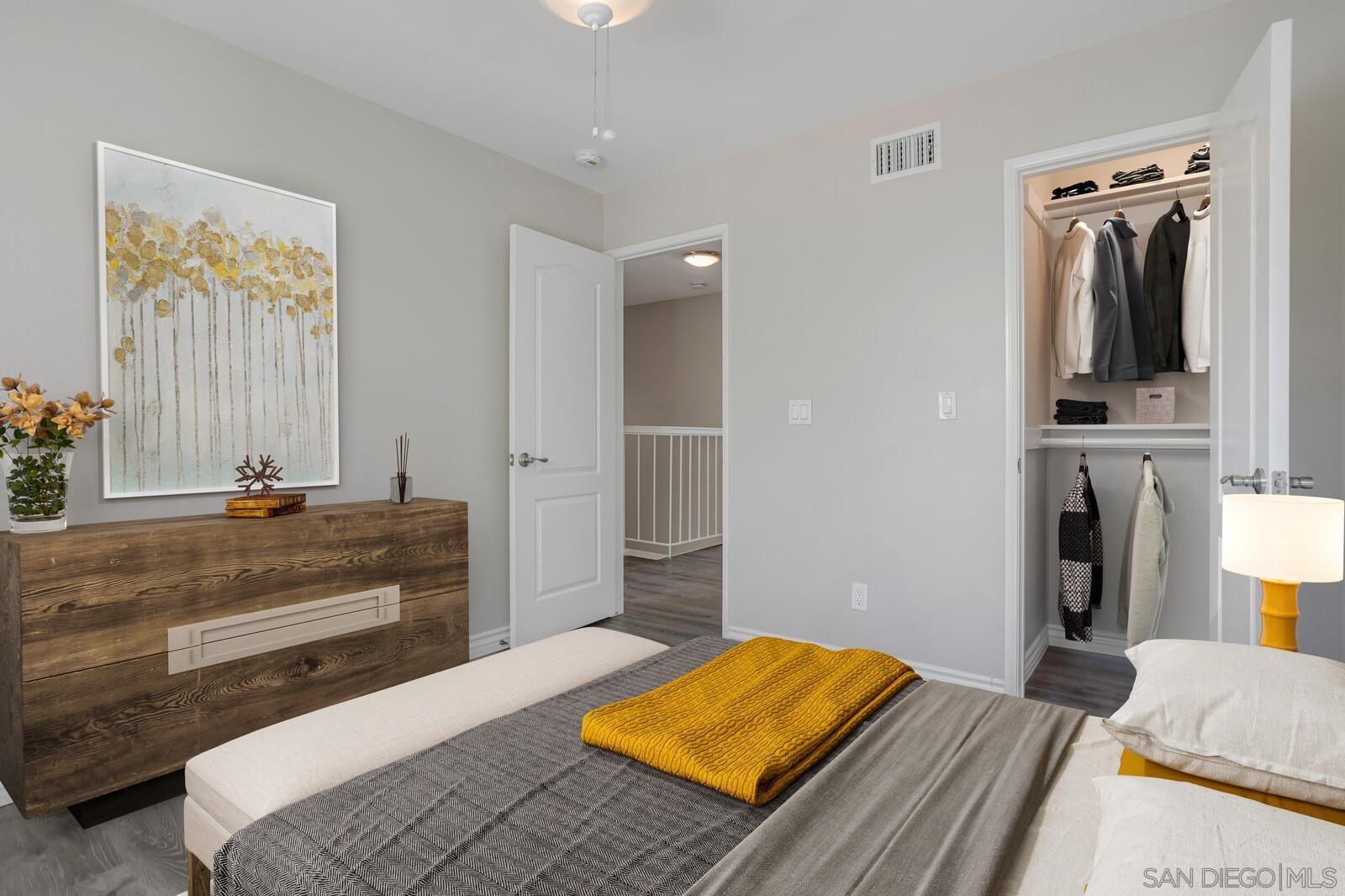 815 Del Mar Downs Road, Unit C Solana Beach, CA 92075 - Photo 3 of 19 a bedroom with a bed and a dresser in it