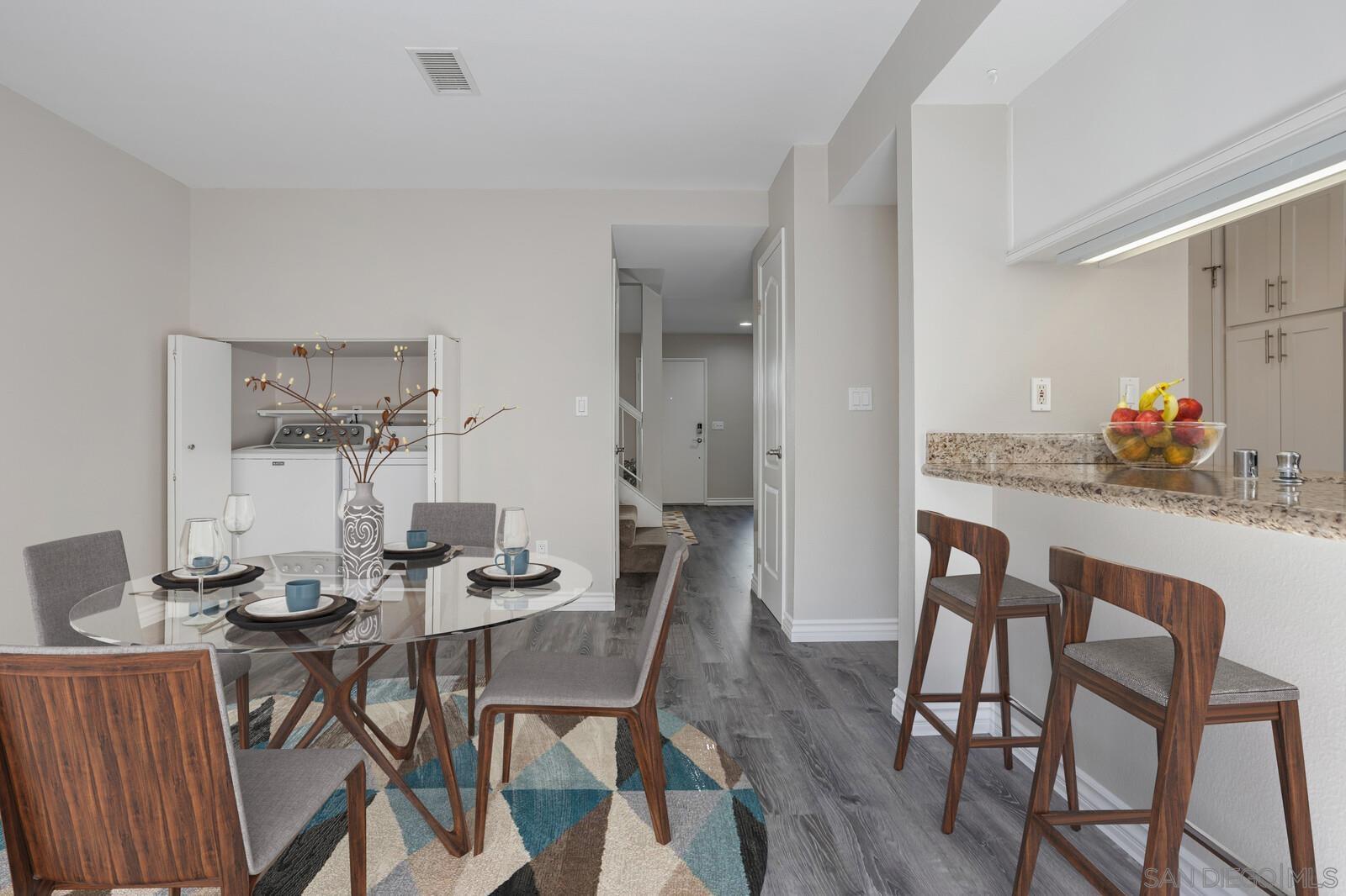815 Del Mar Downs Road, Unit C Solana Beach, CA 92075 - Photo 5 of 19 a view of a dining room with furniture and wooden floor