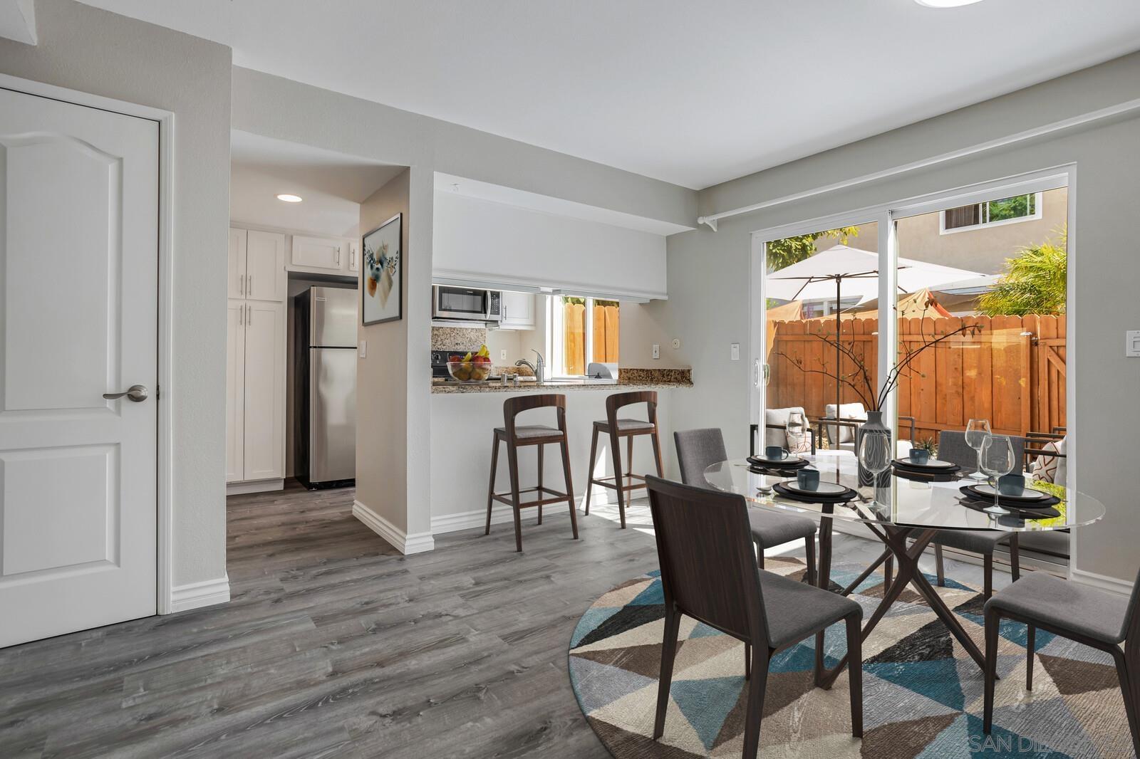 815 Del Mar Downs Road, Unit C Solana Beach, CA 92075 - Photo 6 of 19 a dining room with furniture and wooden floor