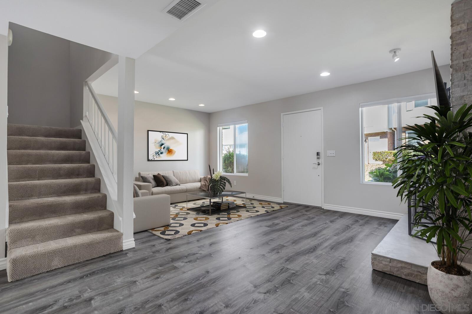 815 Del Mar Downs Road, Unit C Solana Beach, CA 92075 - Photo 9 of 19 a living room with furniture and a potted plant