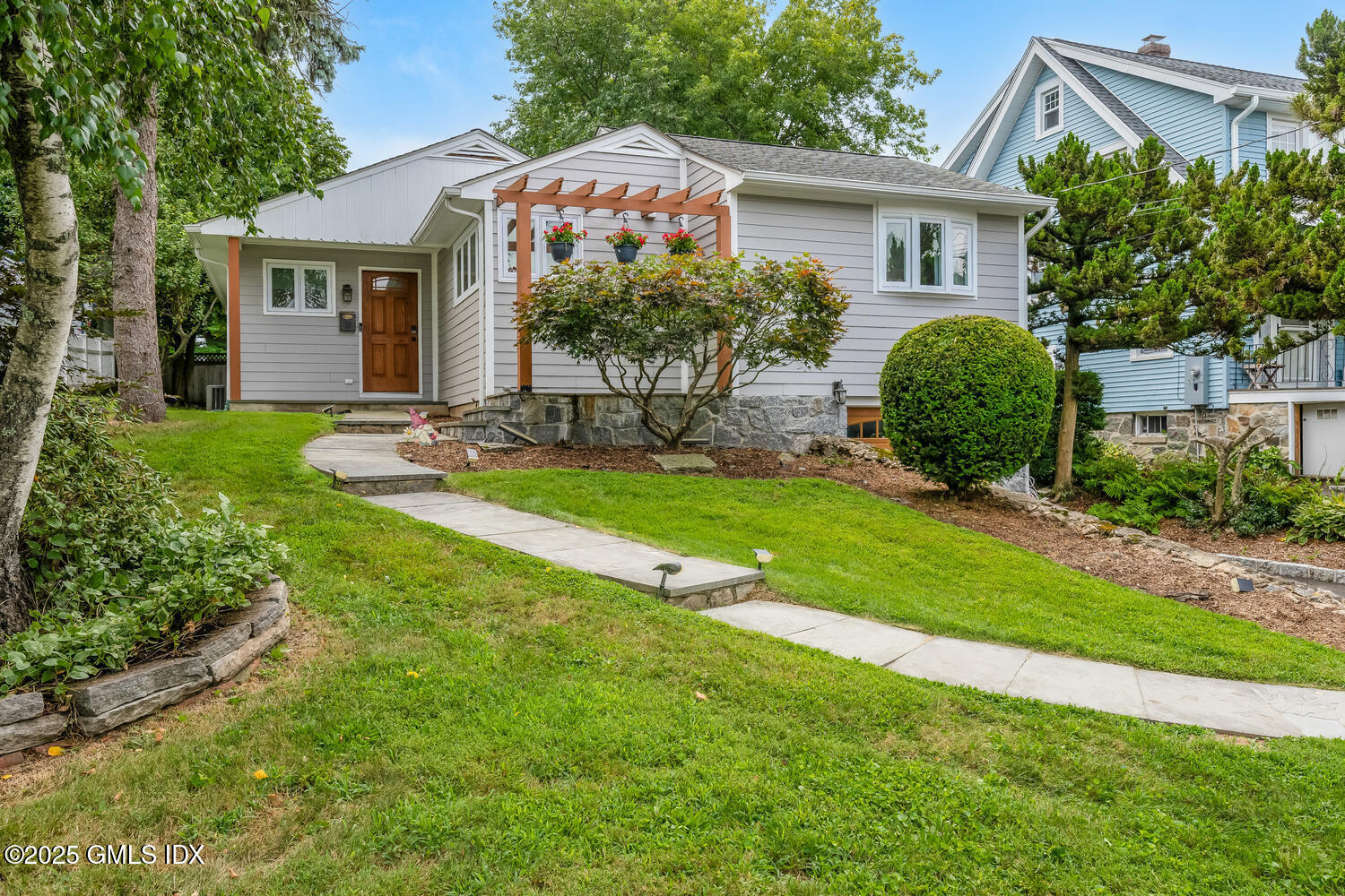a front view of a house with a yard and porch