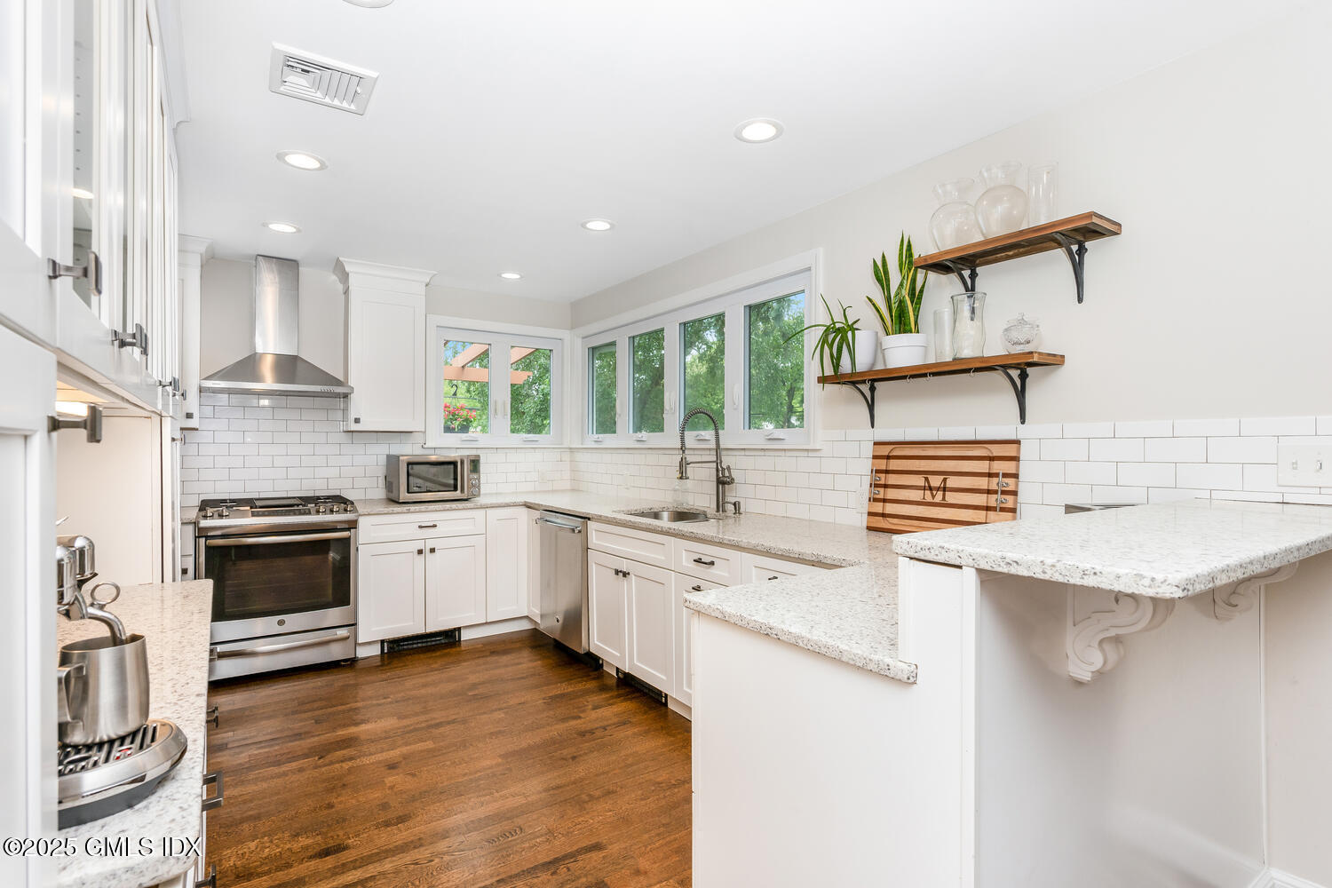 19 High Street Greenwich, CT 06830 - Photo 11 of 25 a kitchen with stainless steel appliances granite countertop a stove sink and cabinets