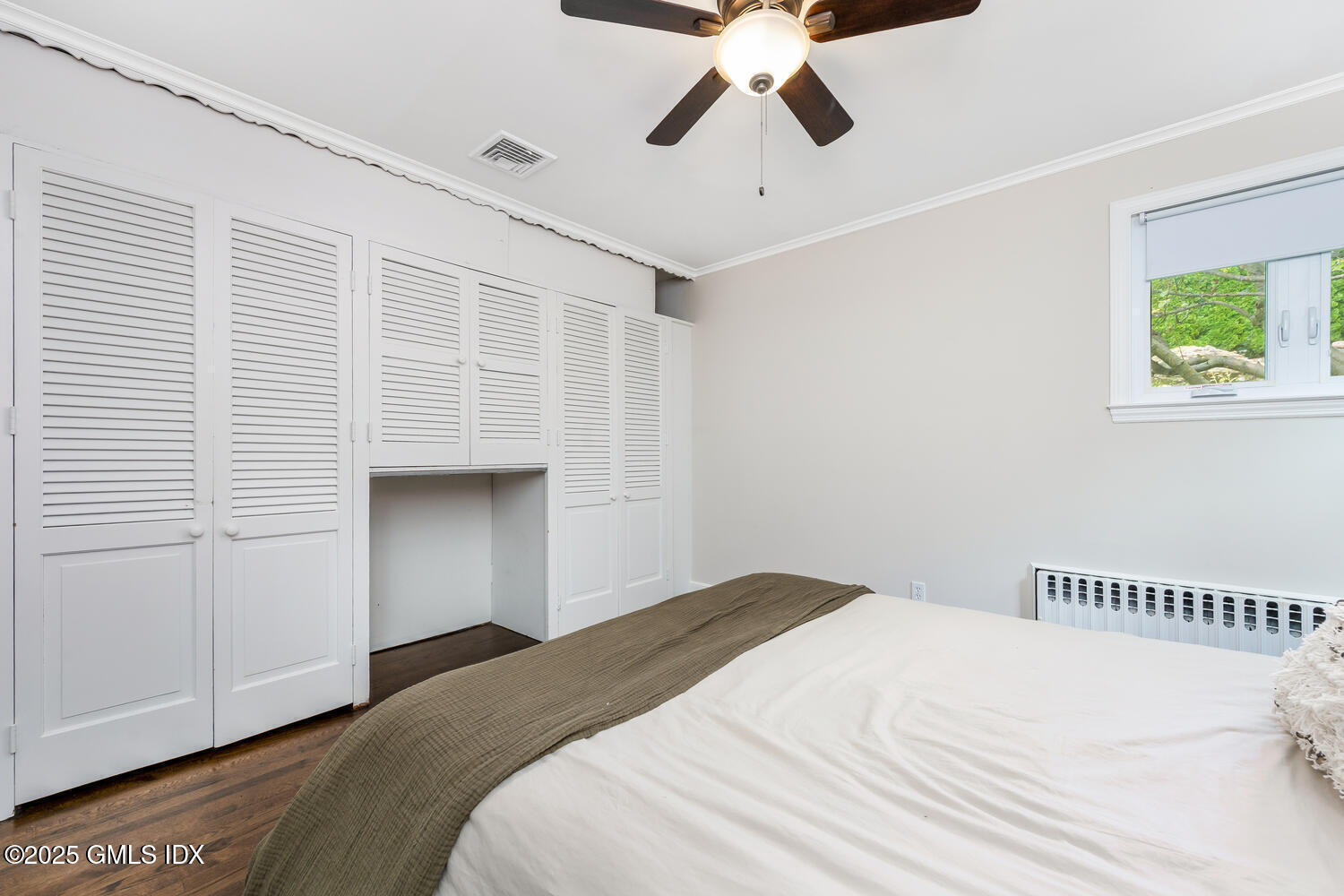 19 High Street Greenwich, CT 06830 - Photo 17 of 25 a bedroom with a large bed and a chandelier