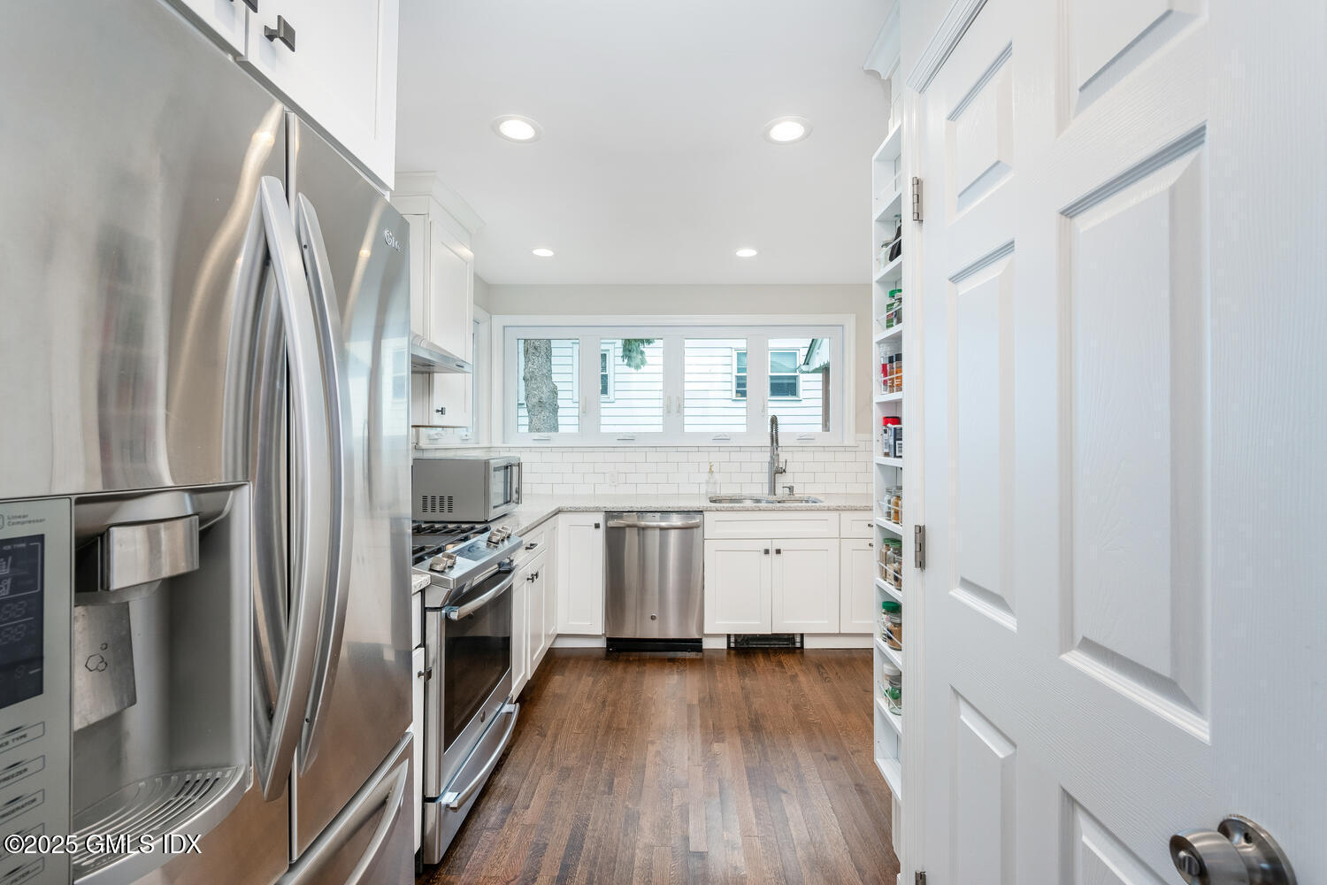19 High Street Greenwich, CT 06830 - Photo 9 of 25 a kitchen with a sink stainless steel appliances and cabinets