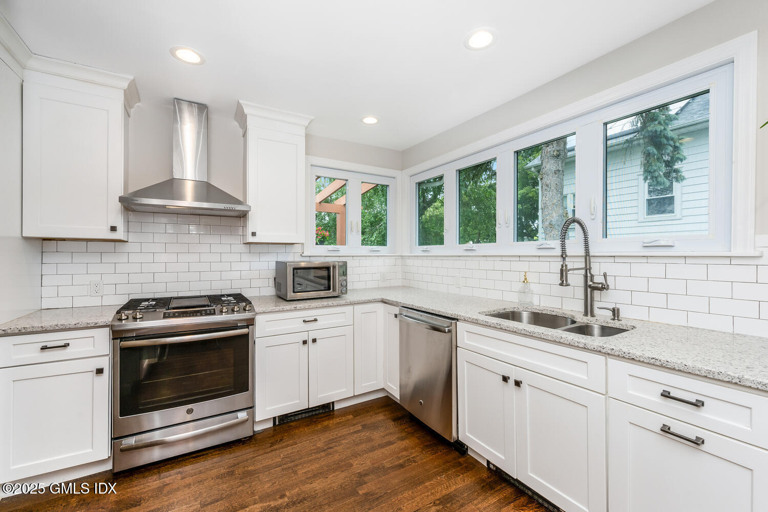 19 High Street Greenwich, CT 06830 - Photo 10 of 25 a kitchen with stainless steel appliances granite countertop a sink stove and cabinets