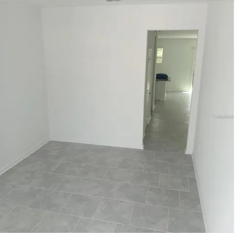 an empty room with mirror in bathroom