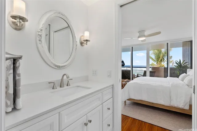 a bedroom with a bed a mirror on the wall and a dresser