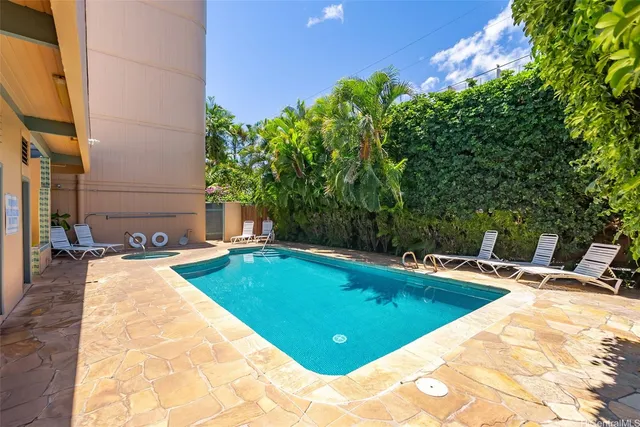 a view of swimming pool with a house in the background