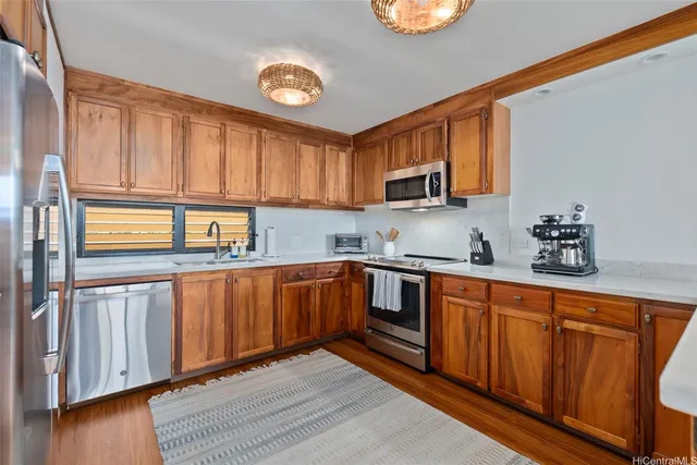 a kitchen with stainless steel appliances granite countertop a refrigerator sink and cabinets