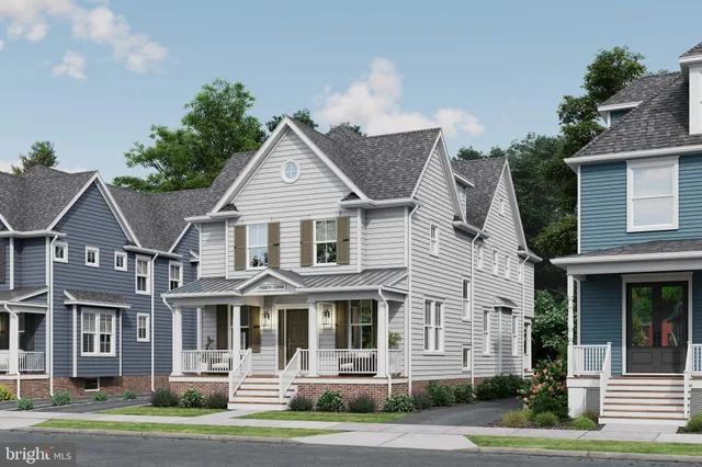 a front view of a residential apartment building with a yard