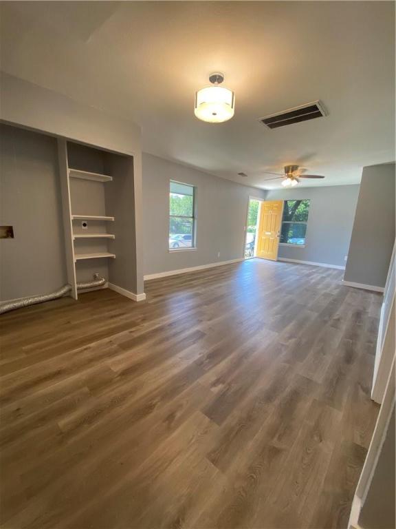 511 Central Avenue, Unit A Elgin, TX 78621 - Photo 4 of 10 wooden floor in an empty room with a window