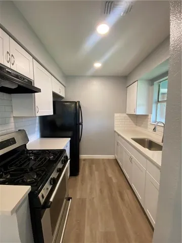 a kitchen with a stove and a refrigerator