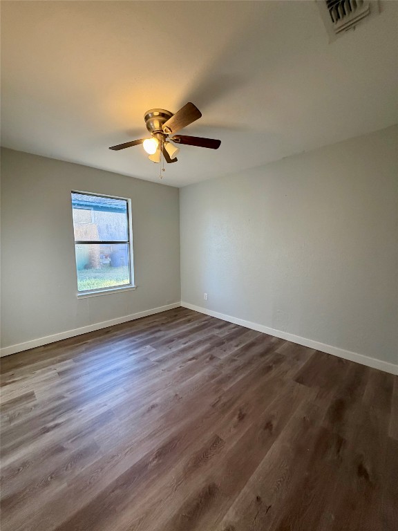 511 Central Avenue, Unit A Elgin, TX 78621 - Photo 9 of 10 a view of an empty room with a window and wooden floor