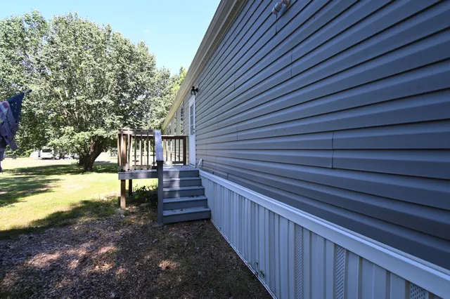a view of an house with backyard and furniture