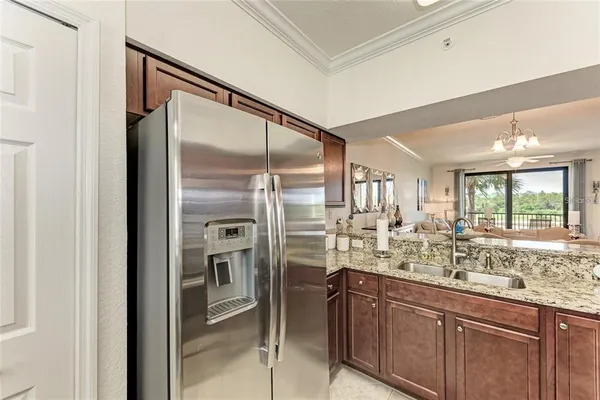 a kitchen with stainless steel appliances granite countertop a refrigerator and a sink
