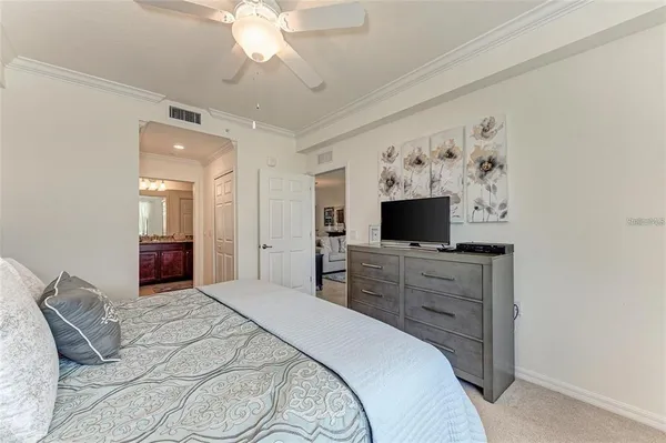 a bedroom with a large bed and a flat screen tv