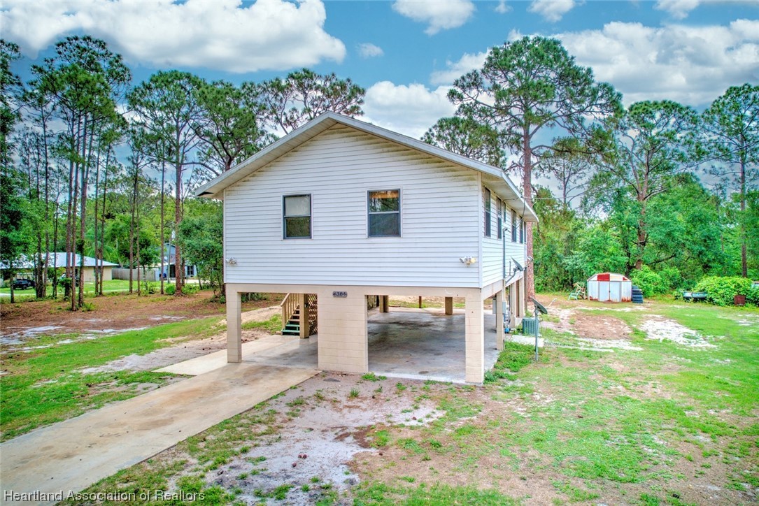a view of a house with yard and a garden