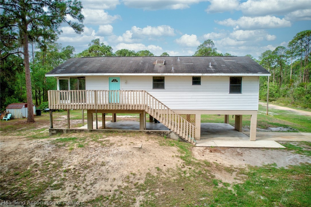 6304 Gunner Terrace Sebring, FL 33875 - Photo 13 of 41 a view of a house with a yard and deck