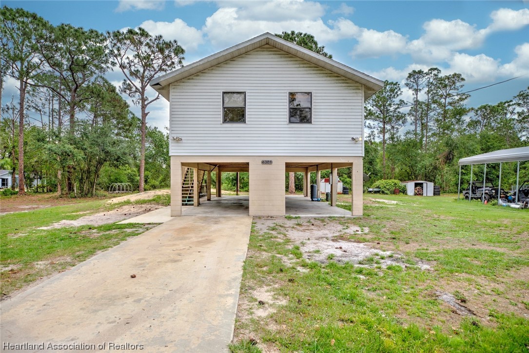 6304 Gunner Terrace Sebring, FL 33875 - Photo 16 of 41 a front view of house with yard and green space