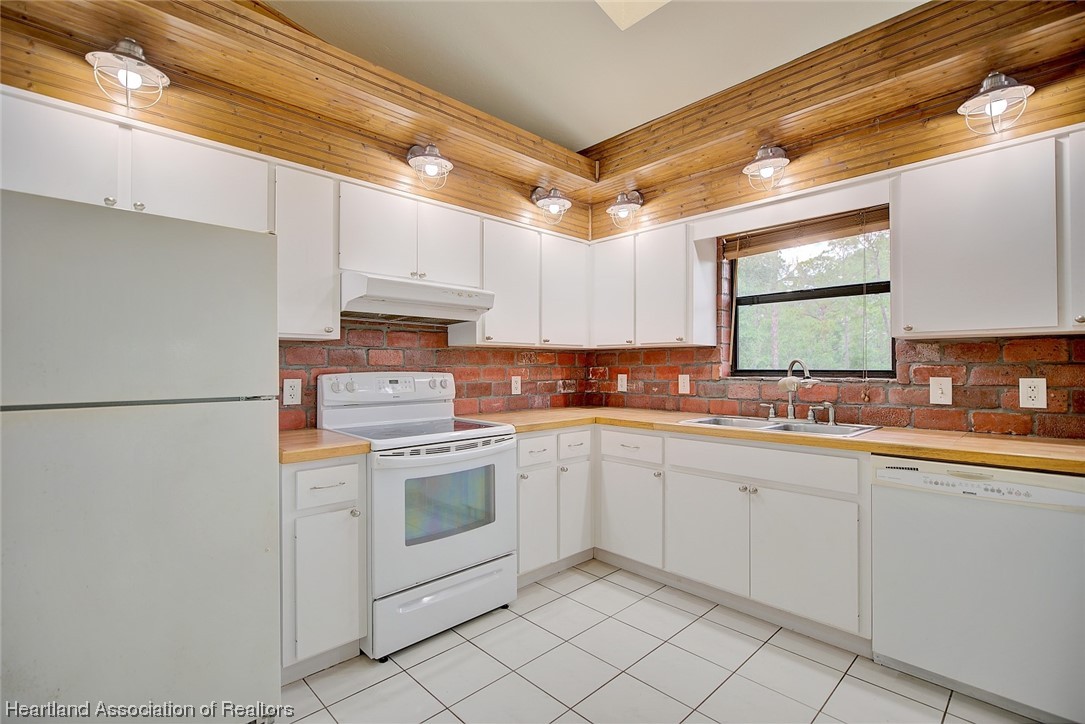 6304 Gunner Terrace Sebring, FL 33875 - Photo 2 of 41 a kitchen with cabinets appliances a sink and a window