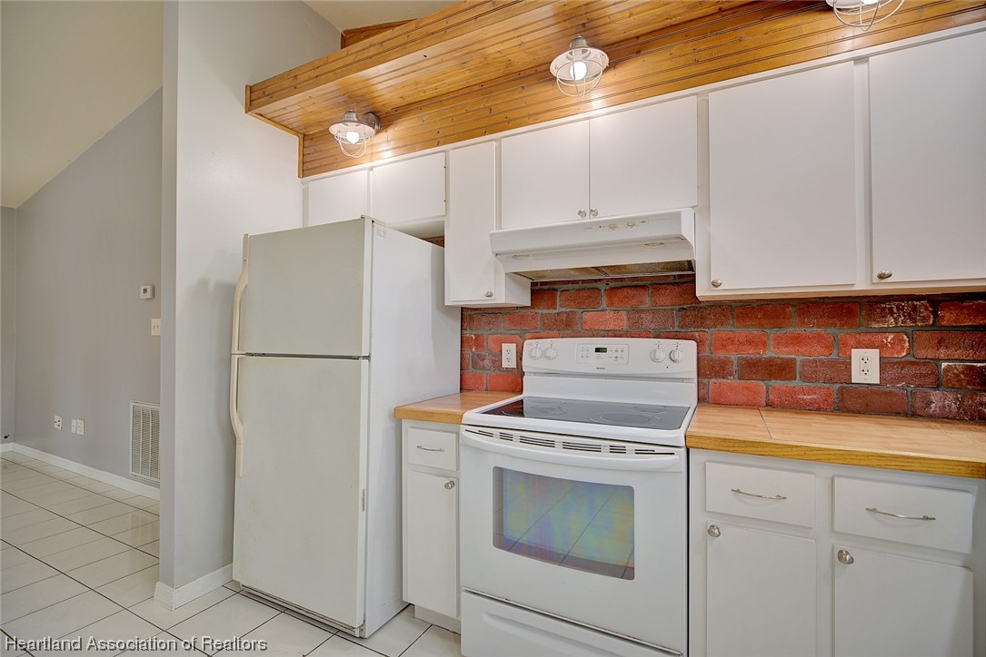 6304 Gunner Terrace Sebring, FL 33875 - Photo 23 of 41 a kitchen with white cabinets and white appliances