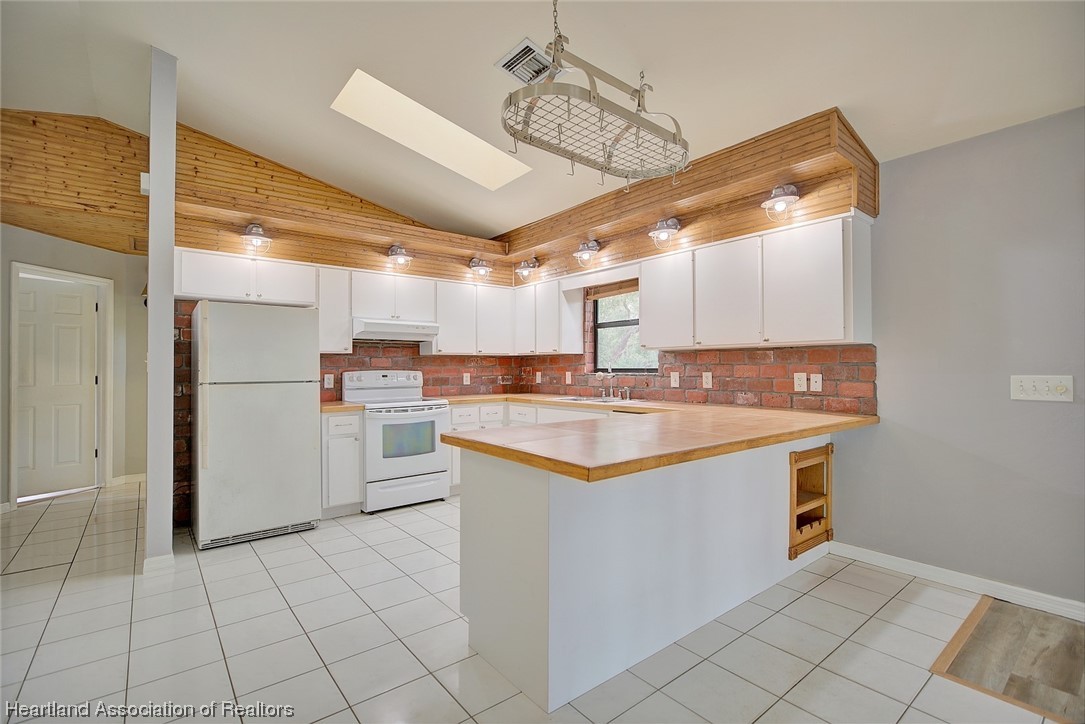 6304 Gunner Terrace Sebring, FL 33875 - Photo 25 of 41 a kitchen with stainless steel appliances granite countertop a sink and cabinets