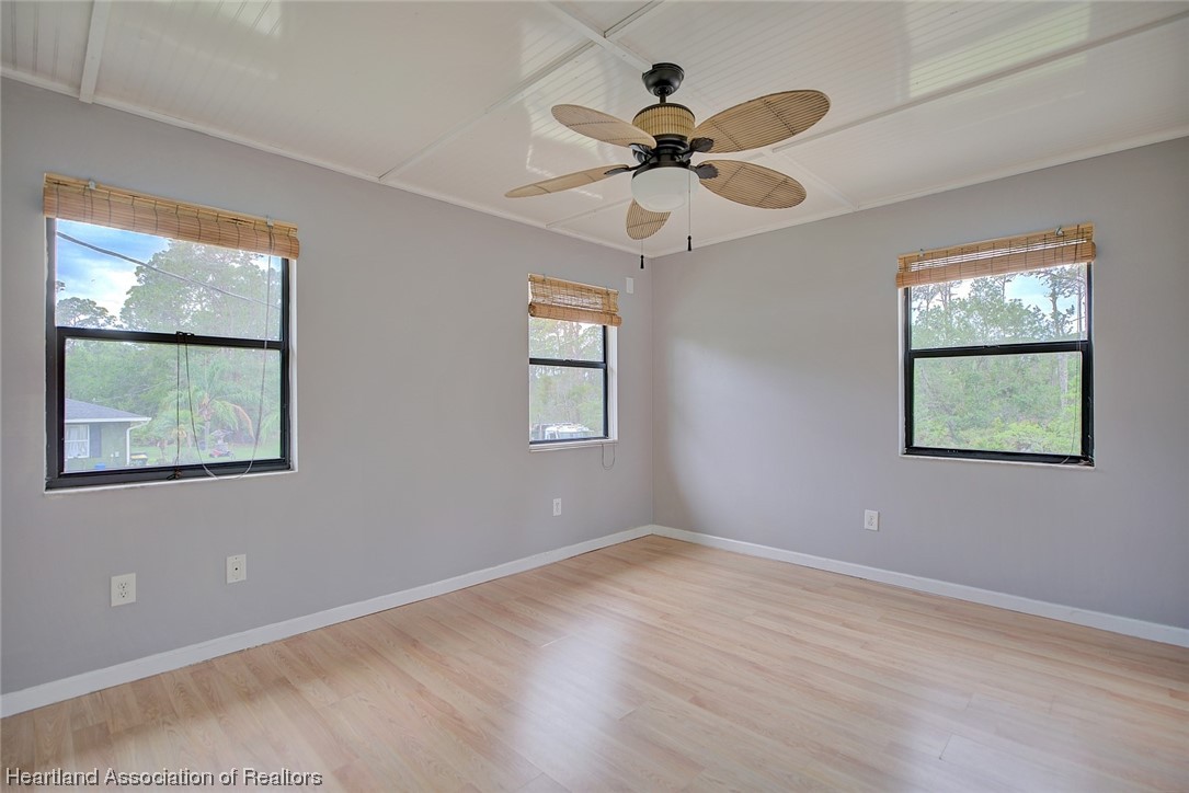 6304 Gunner Terrace Sebring, FL 33875 - Photo 26 of 41 a view of a big room with wooden floor and windows