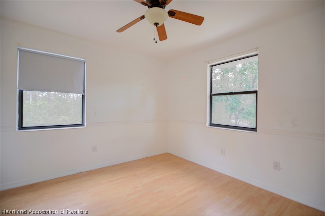 6304 Gunner Terrace Sebring, FL 33875 - Photo 28 of 41 an empty room with windows and cabinet