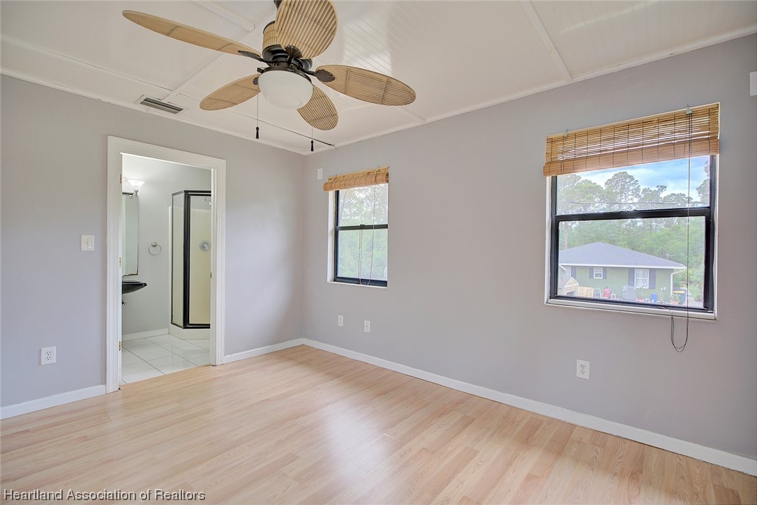 6304 Gunner Terrace Sebring, FL 33875 - Photo 6 of 41 a view of a big room with wooden floor and windows