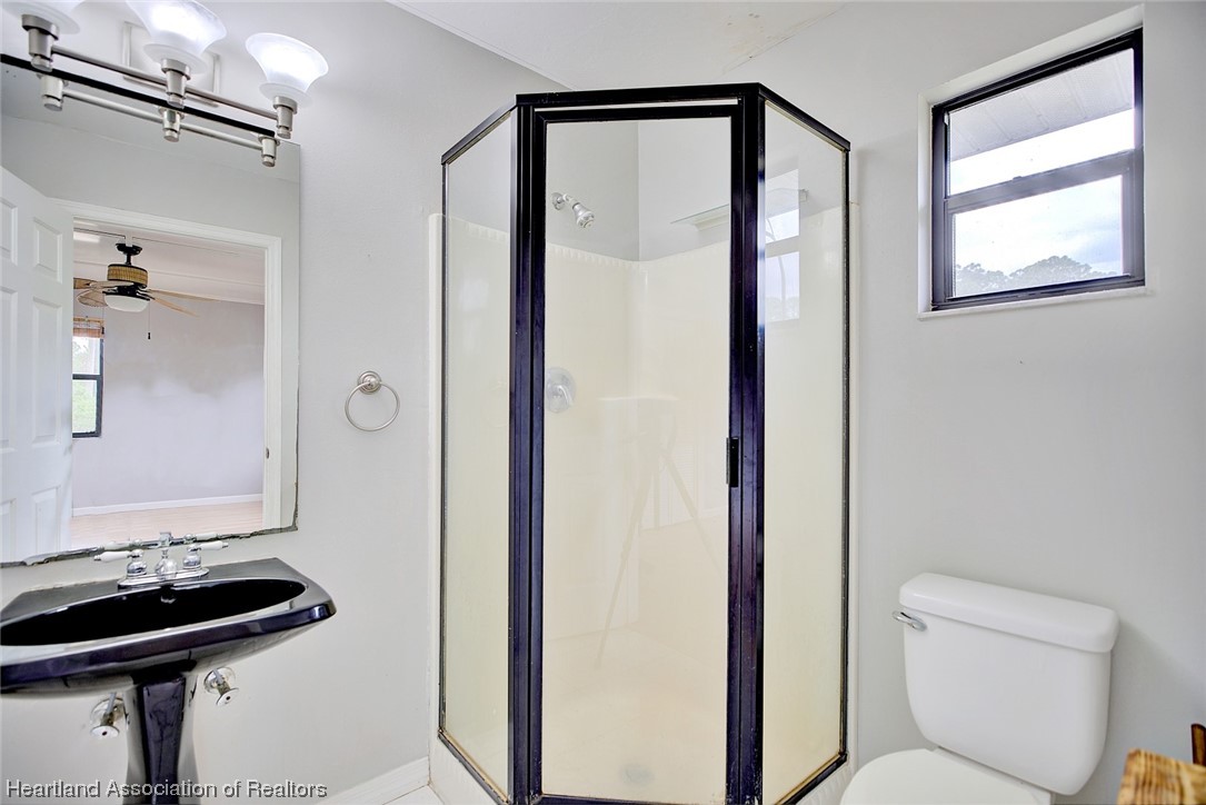 6304 Gunner Terrace Sebring, FL 33875 - Photo 8 of 41 a bathroom with a toilet a sink and shower