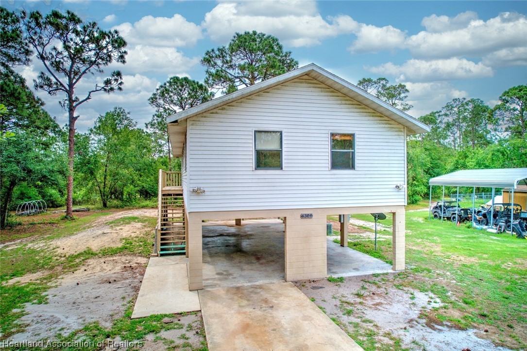 6304 Gunner Terrace Sebring, FL 33875 - Photo 10 of 41 a view of a house with backyard and sitting area
