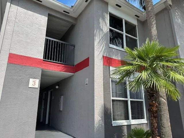 a living room with furniture a flat screen tv and white appliances