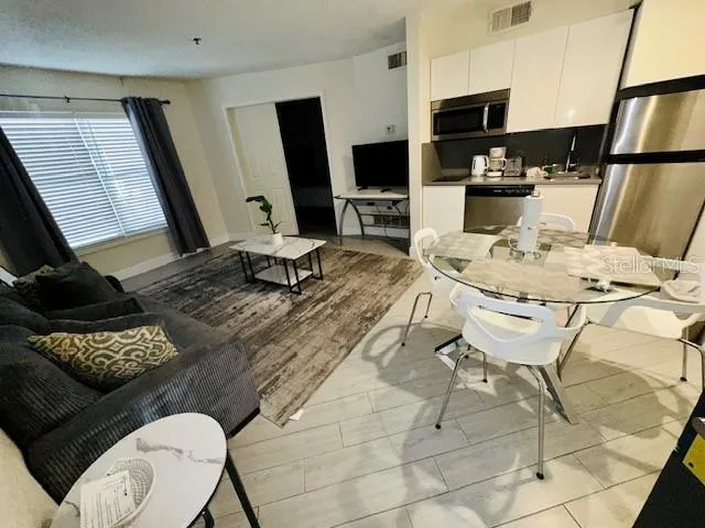 a kitchen with a table chairs and a stove