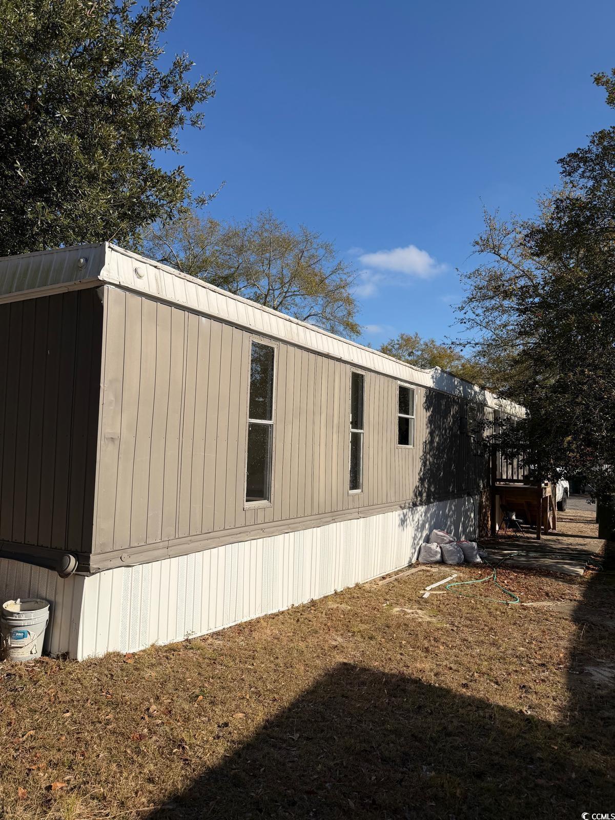 View of side of home featuring a deck