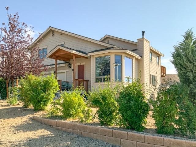 4958 Westridge Road Bishop, CA 93514 - Photo 1 of 24 a front view of a house with a yard and potted plants