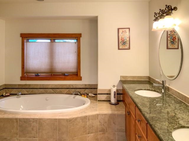 4958 Westridge Road Bishop, CA 93514 - Photo 14 of 24 a bathroom with a granite countertop tub sink and mirror