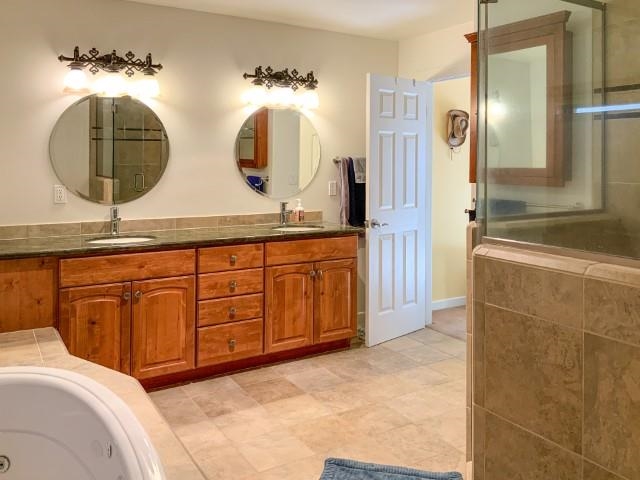 4958 Westridge Road Bishop, CA 93514 - Photo 15 of 24 a spacious bathroom with double vanity and a mirror